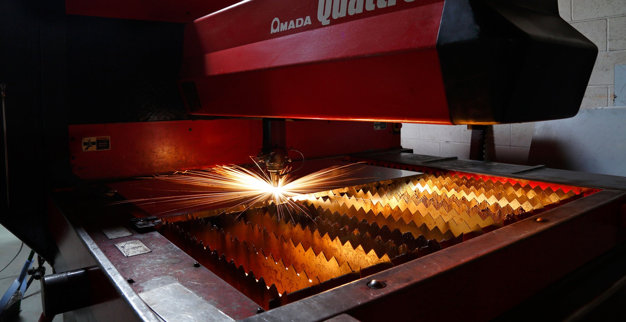 Amada Quattro laser cutter cutting a steel sheet