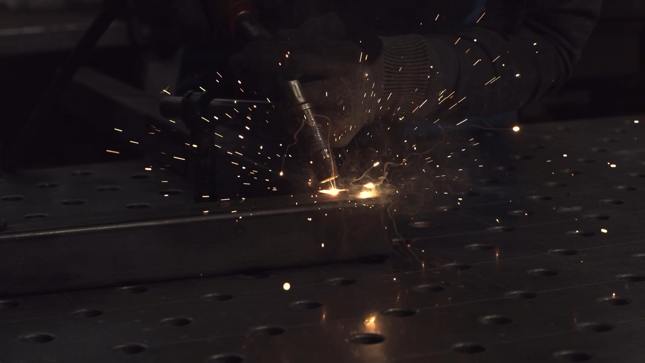 Industrial steel fabrication with bright welding sparks