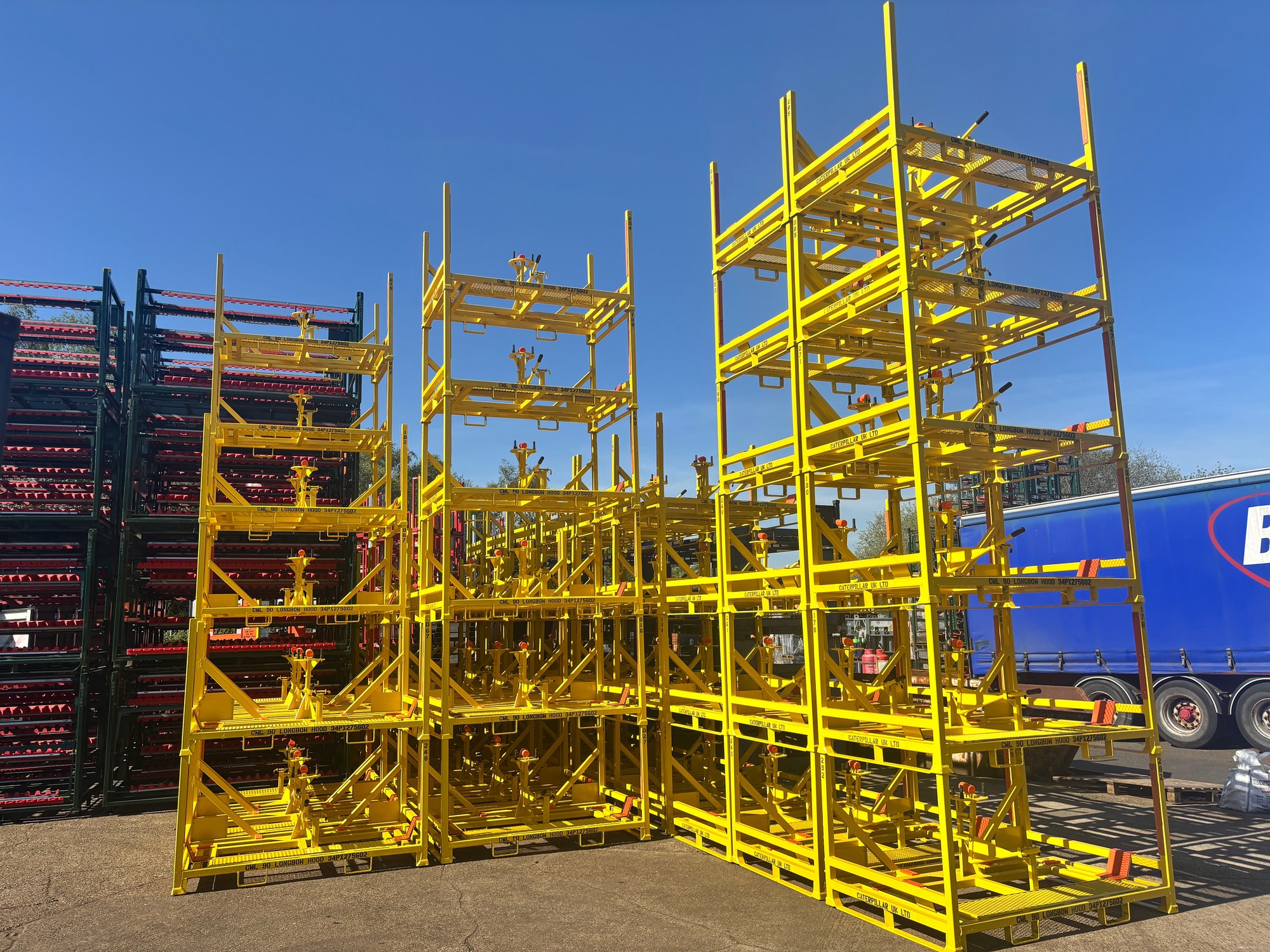 Yellow automotive stillages stacked outside the Bache Pallets workshop